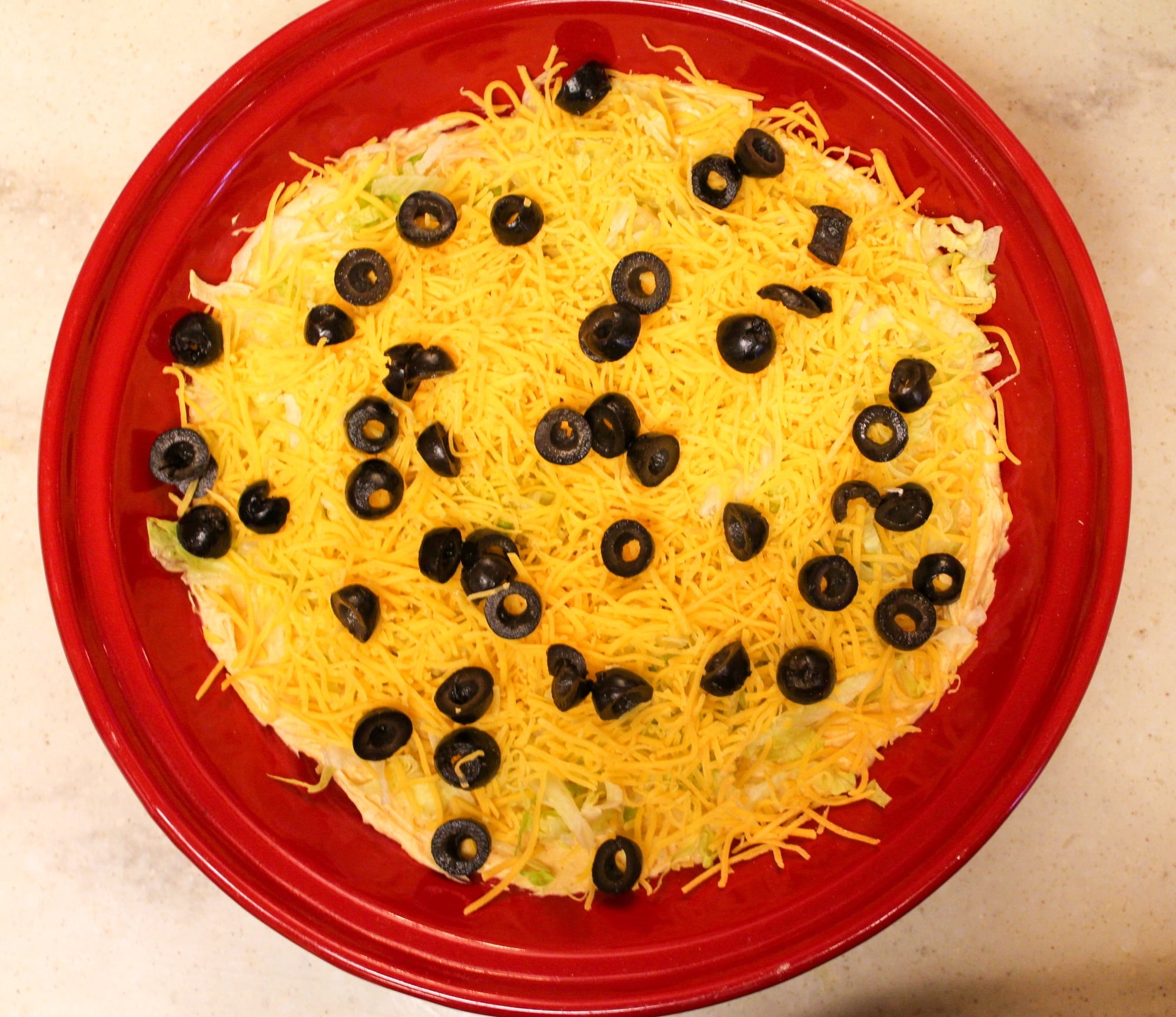 taco dip overhead shot in red plate