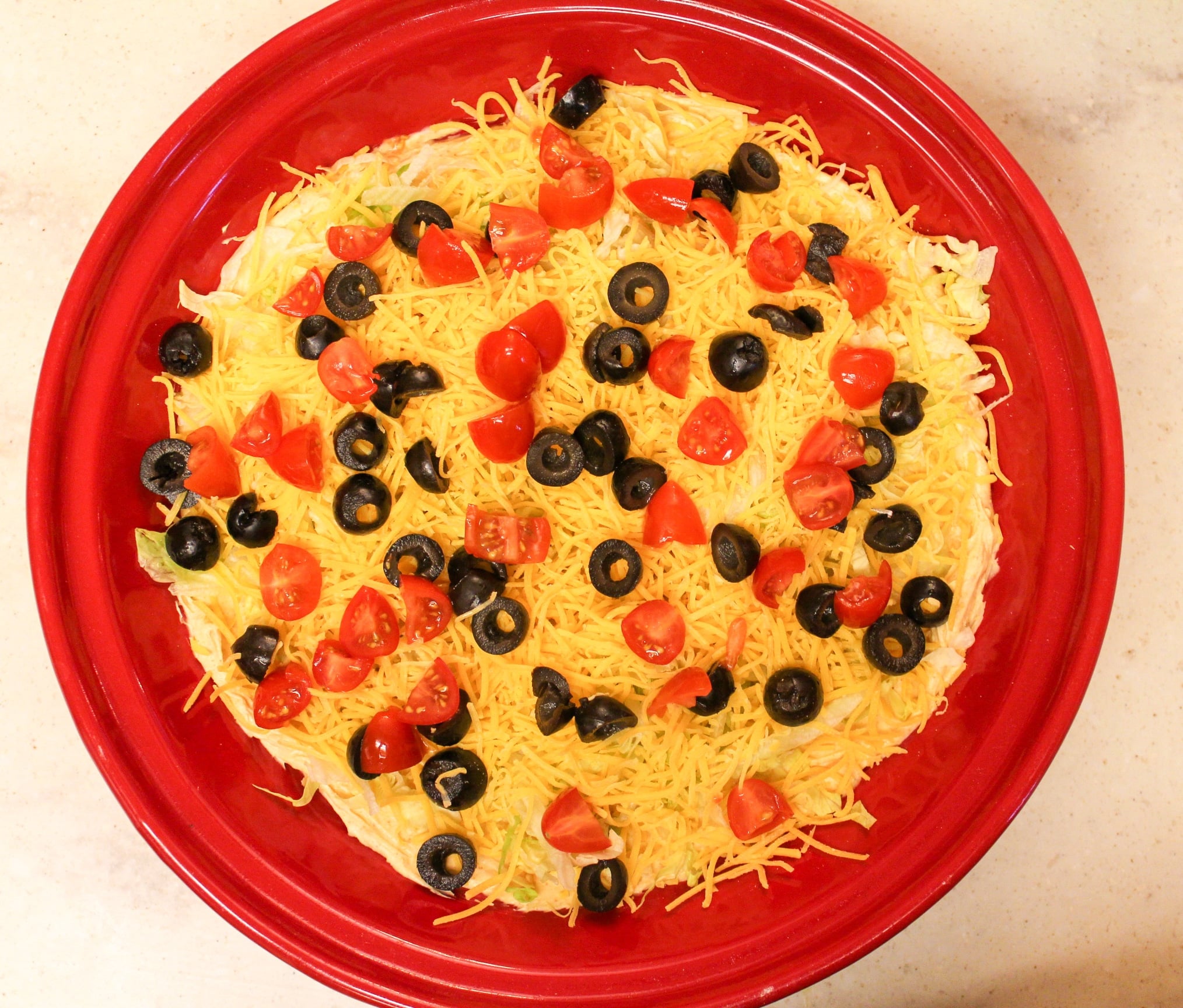 taco dip overhead shot in red plate