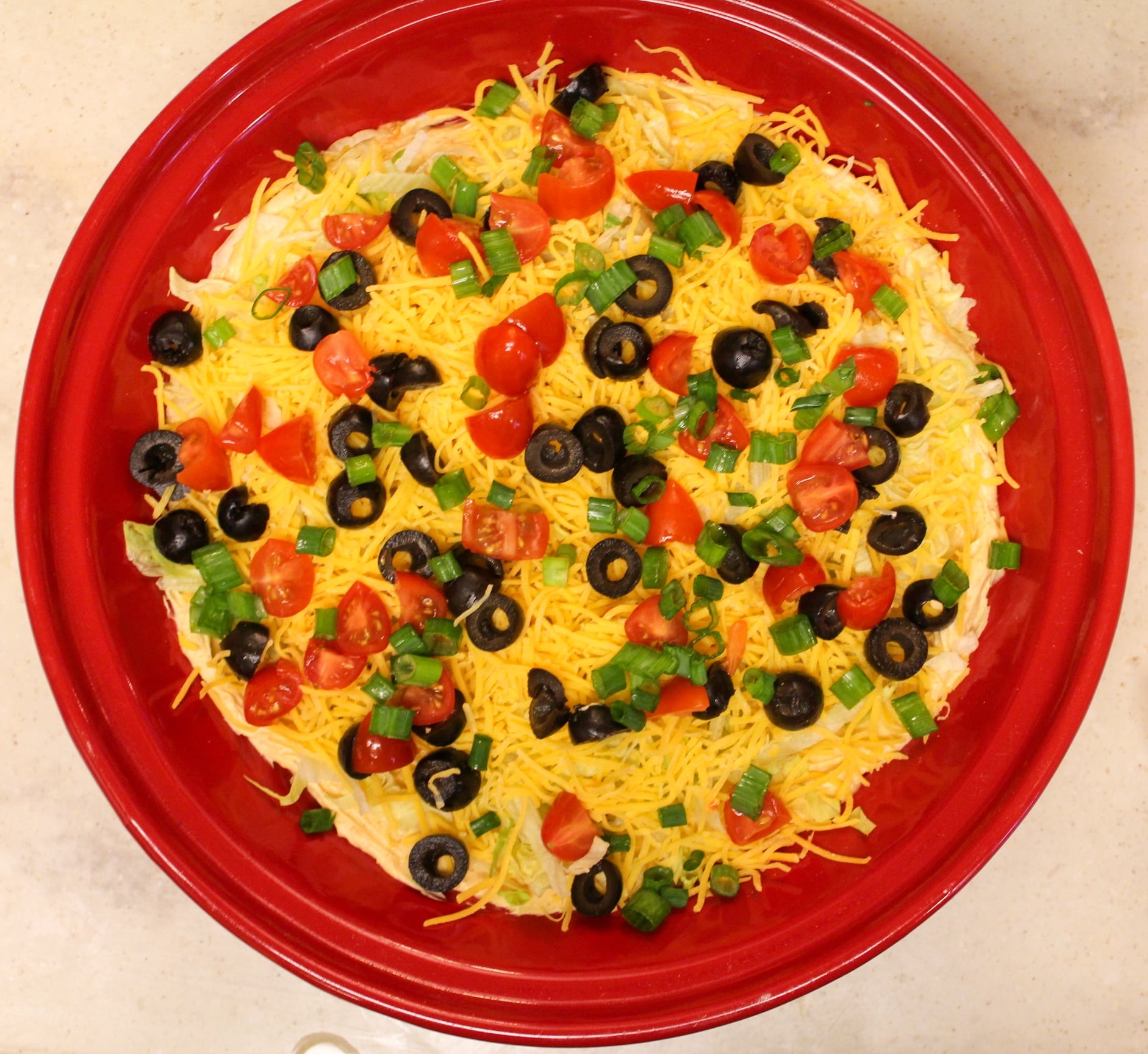 taco dip overhead shot in red plate