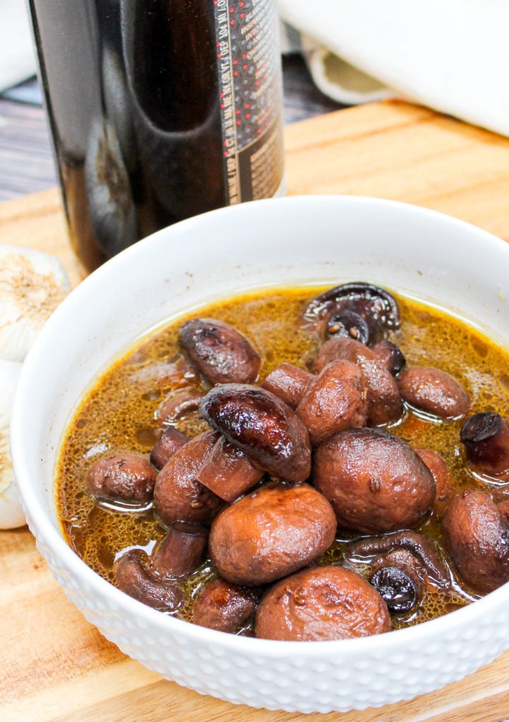 mushrooms in a white bowl with a spoon