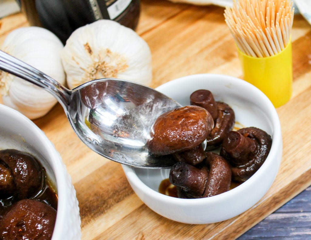 mushrooms in a white bowl with a spoon