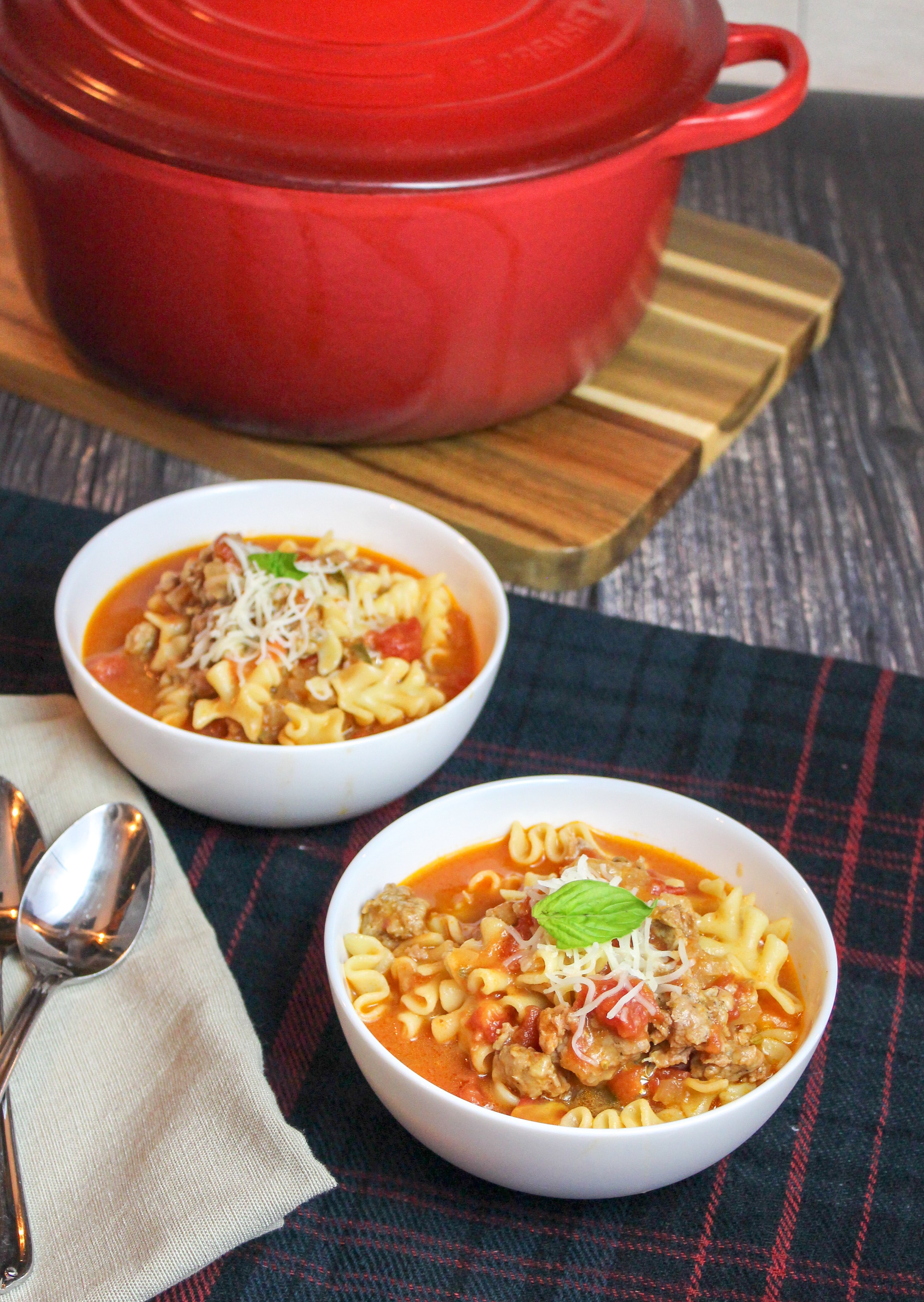 White bowl of soup on a plaid background