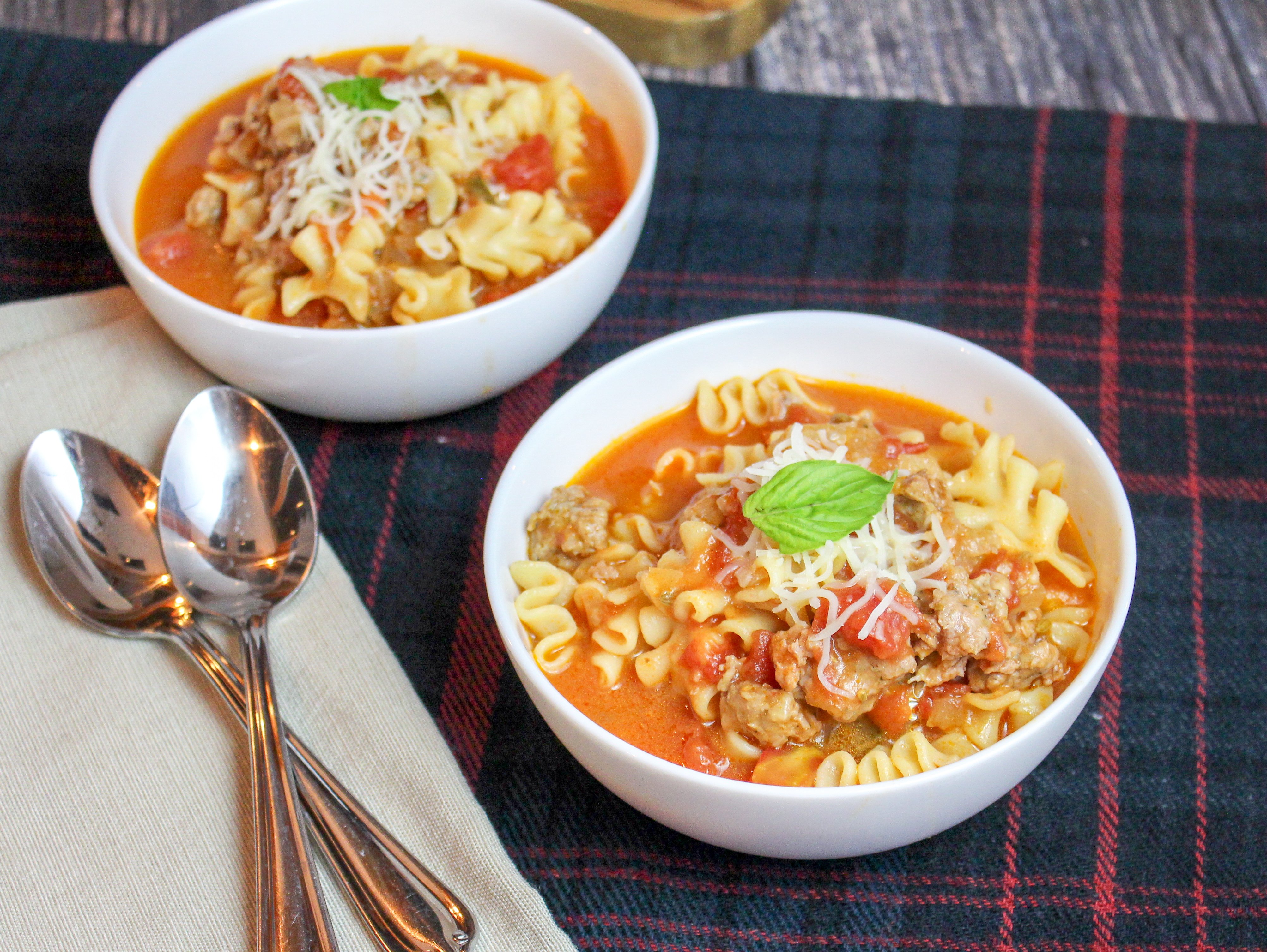 White bowl of soup on a plaid background