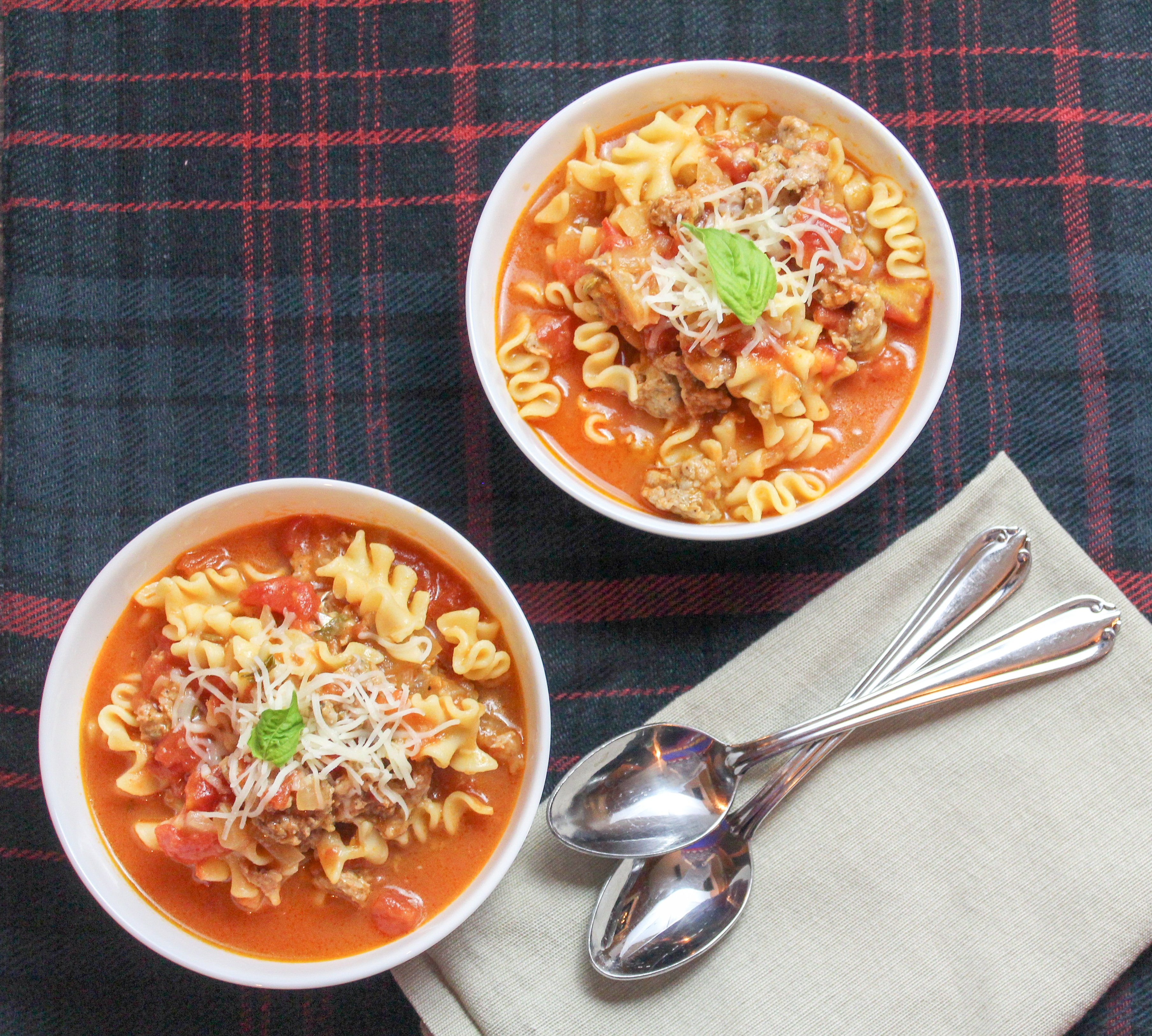 White bowl of soup on a plaid background
