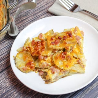 Sliced potatoes, cheese, and diced ham baked in a casserole dish