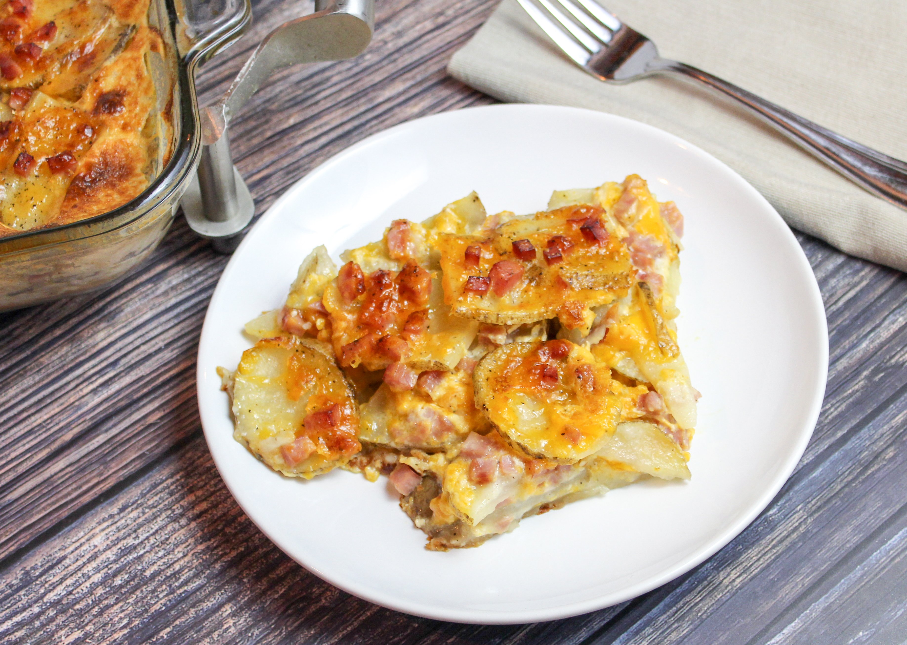 Sliced potatoes, cheese, and diced ham baked in a casserole dish