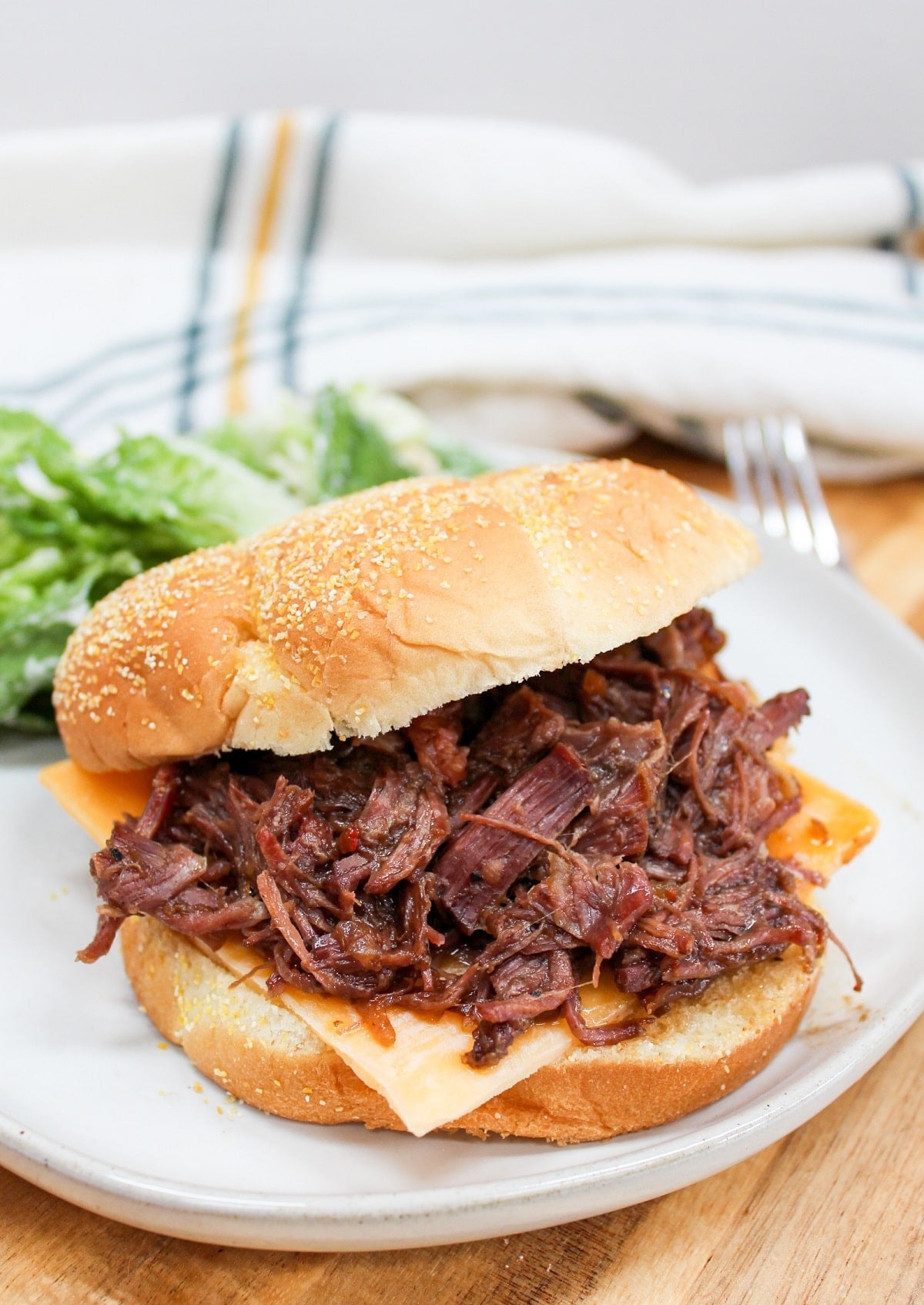 slow cooker hot beef sandwich on a white plate