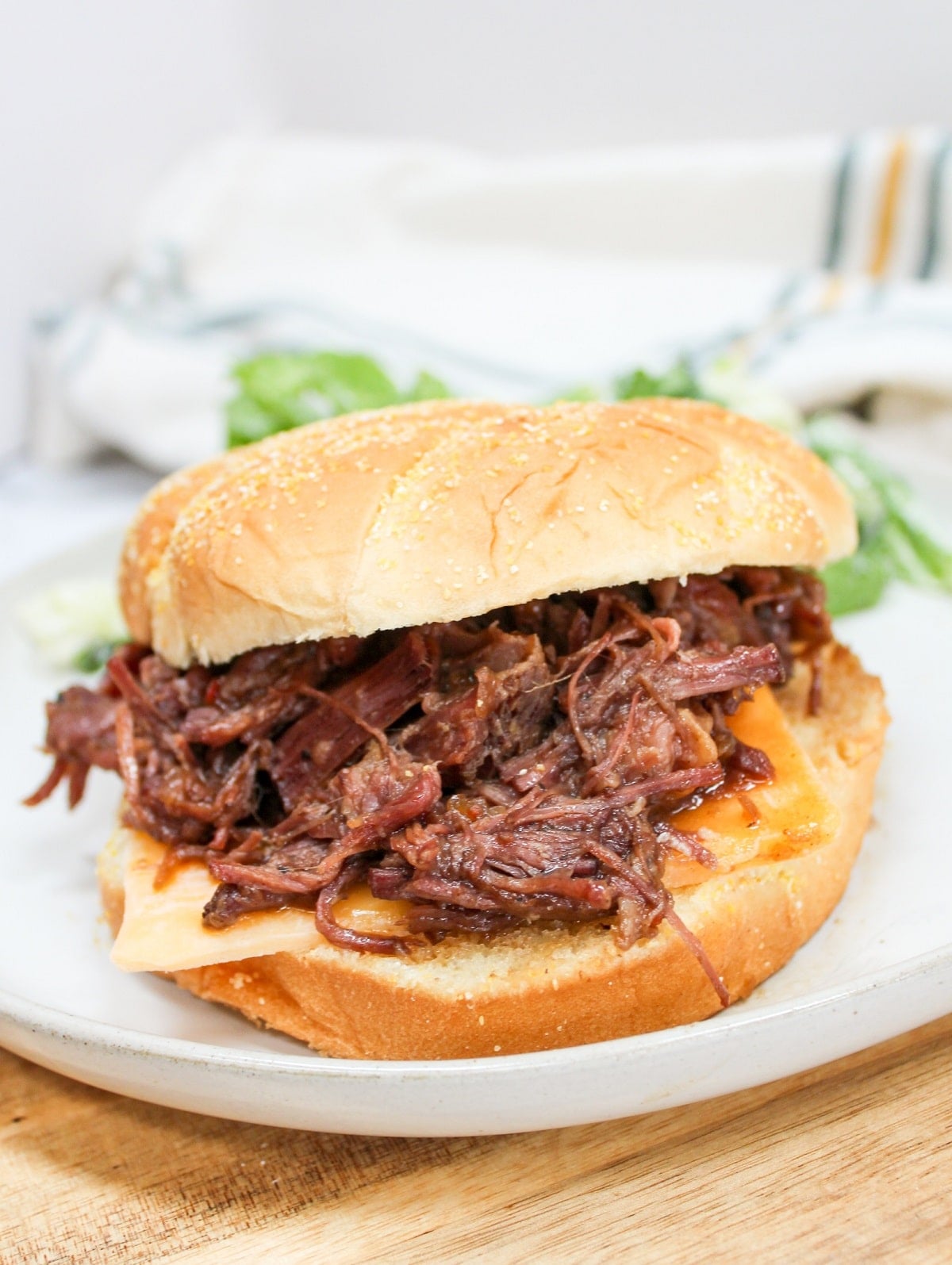 slow cooker hot beef sandwich on a white plate