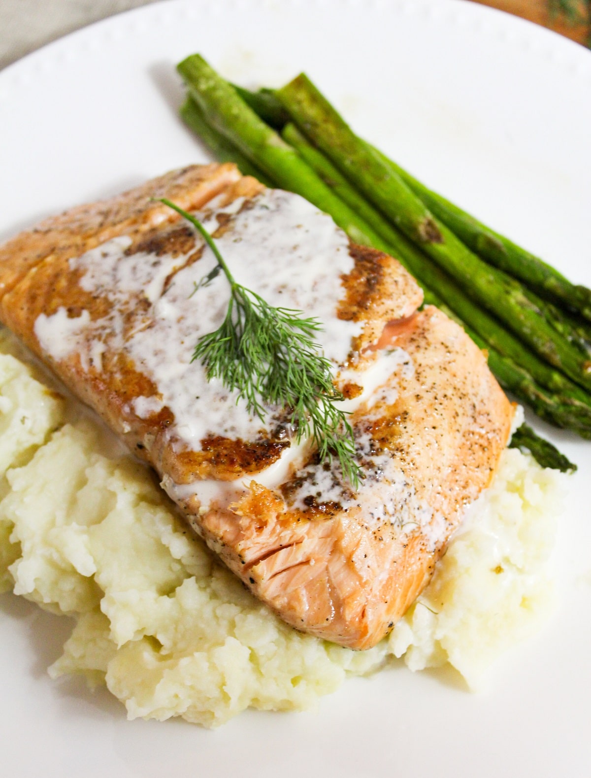 salmon with champagne sauce and dill on top