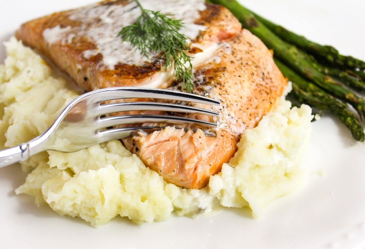 salmon cut with a fork