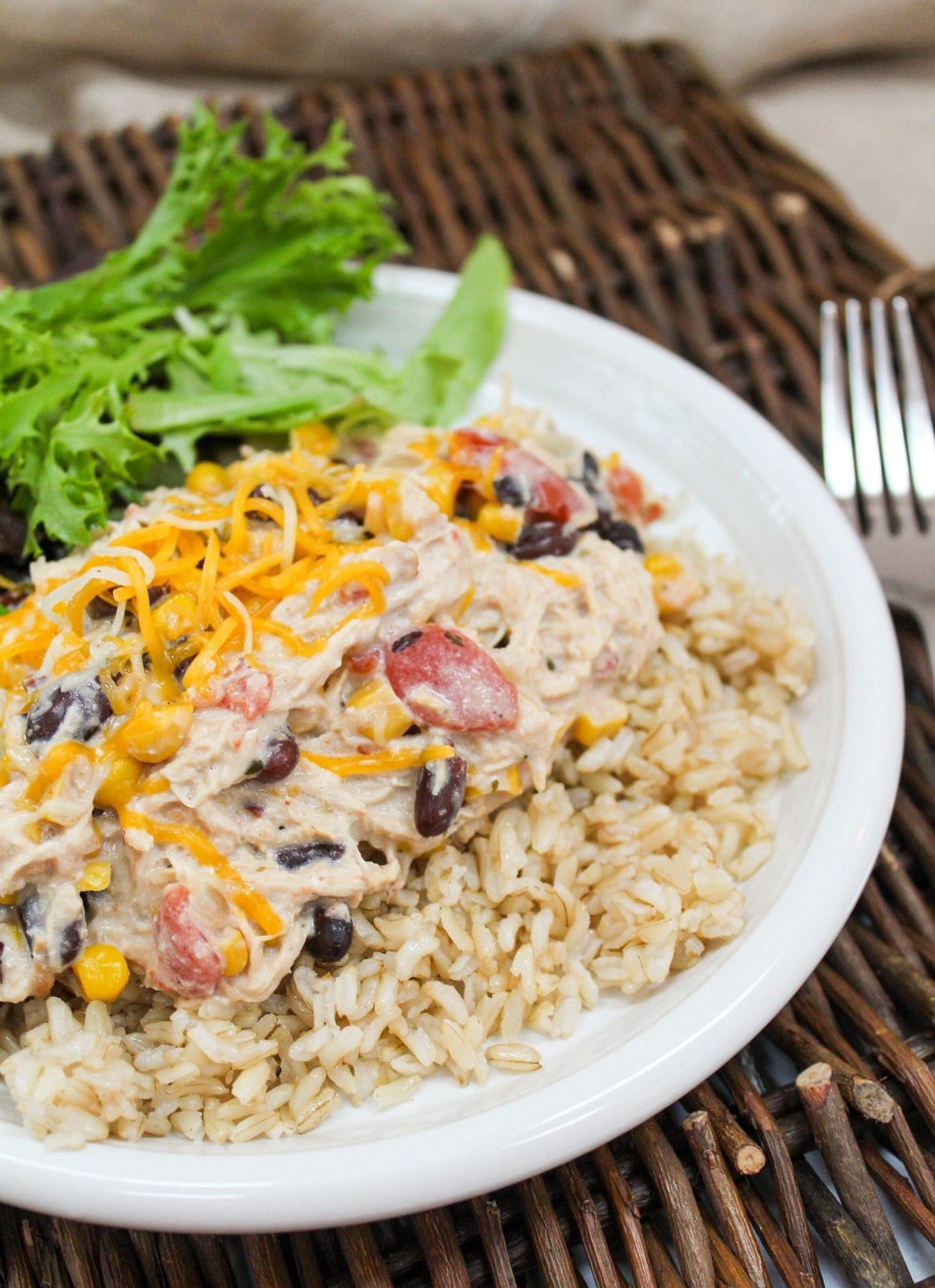 Slow Cooker Cream Cheese Chili Chicken plated over rice