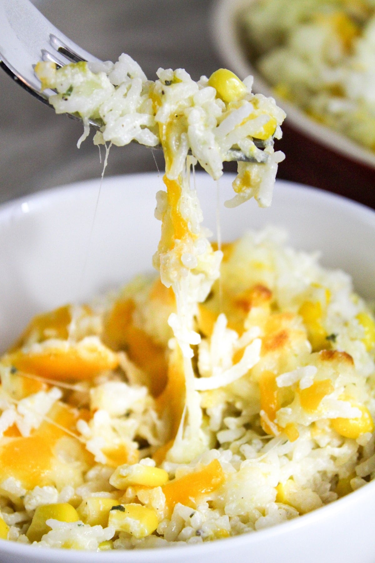 mexican sour cream rice with a fork with cheese