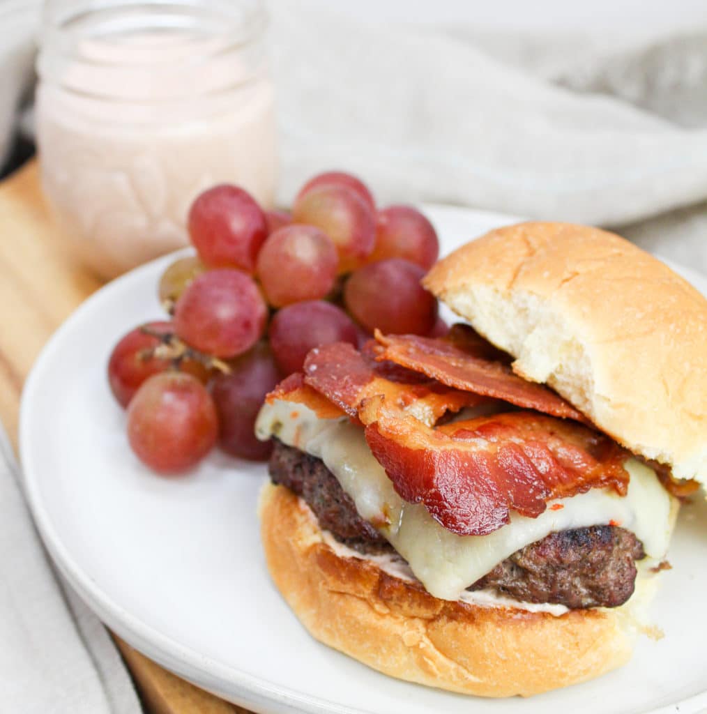 burger on a plate with grapes