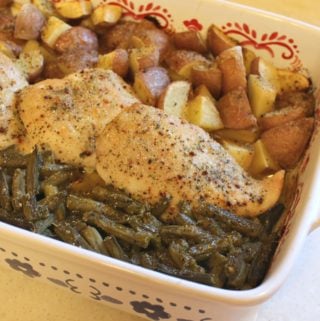 chicken in a baking dish with potatoes and green beans
