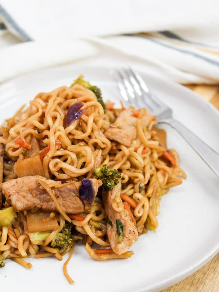 pork stir fry on a plate with fork