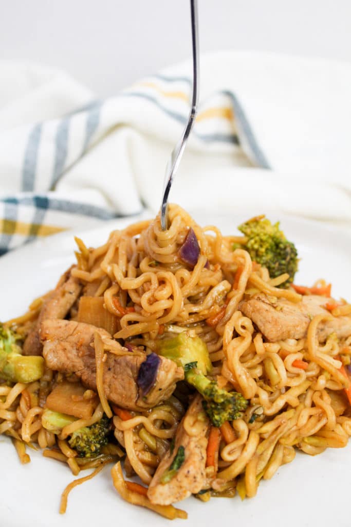 pork stir fry on a plate with fork