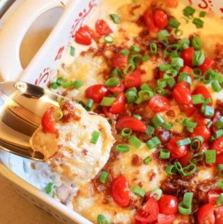 A pierogi scooped from a casserole dish