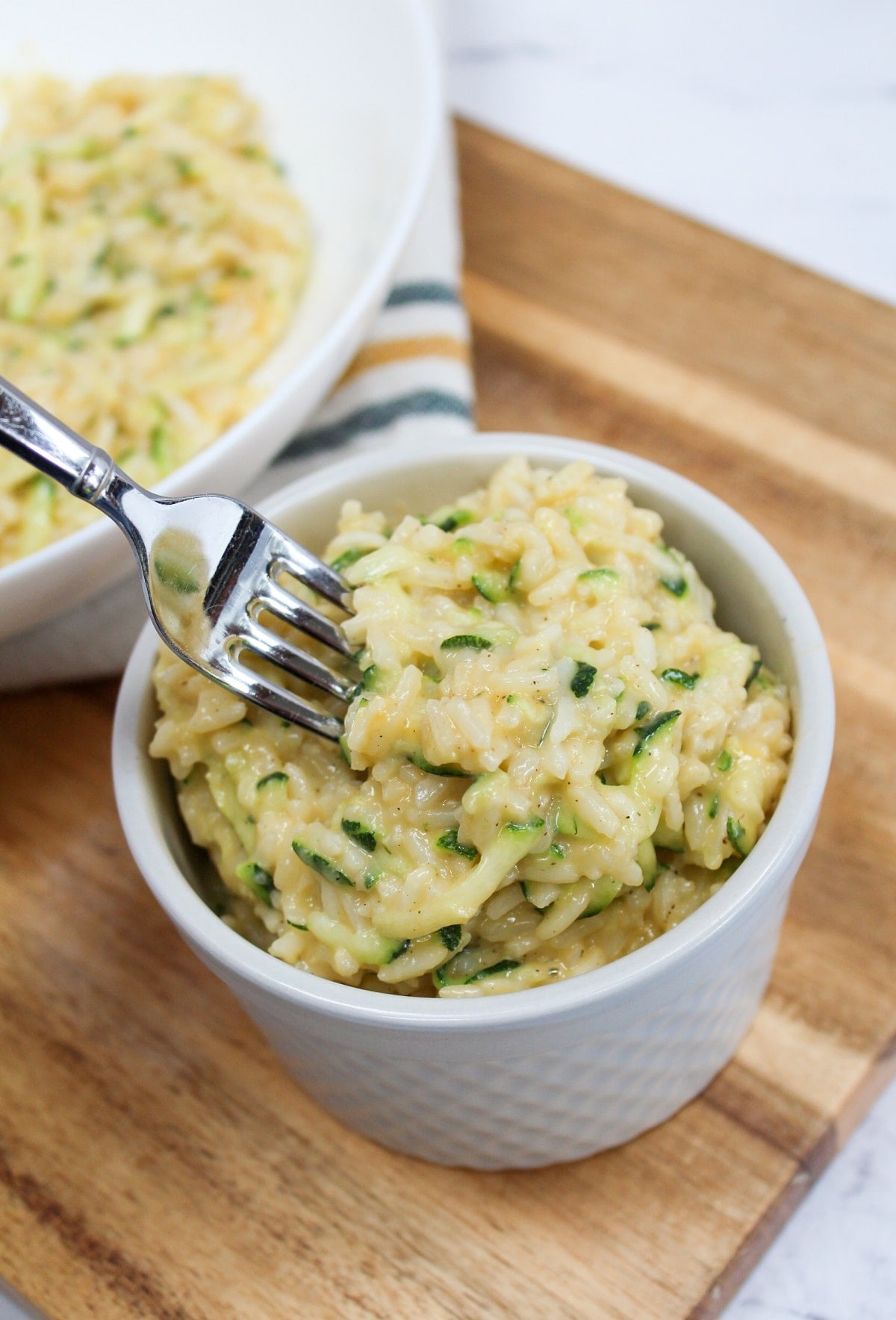 cheesy zucchini rice and fork taking a portion to eat