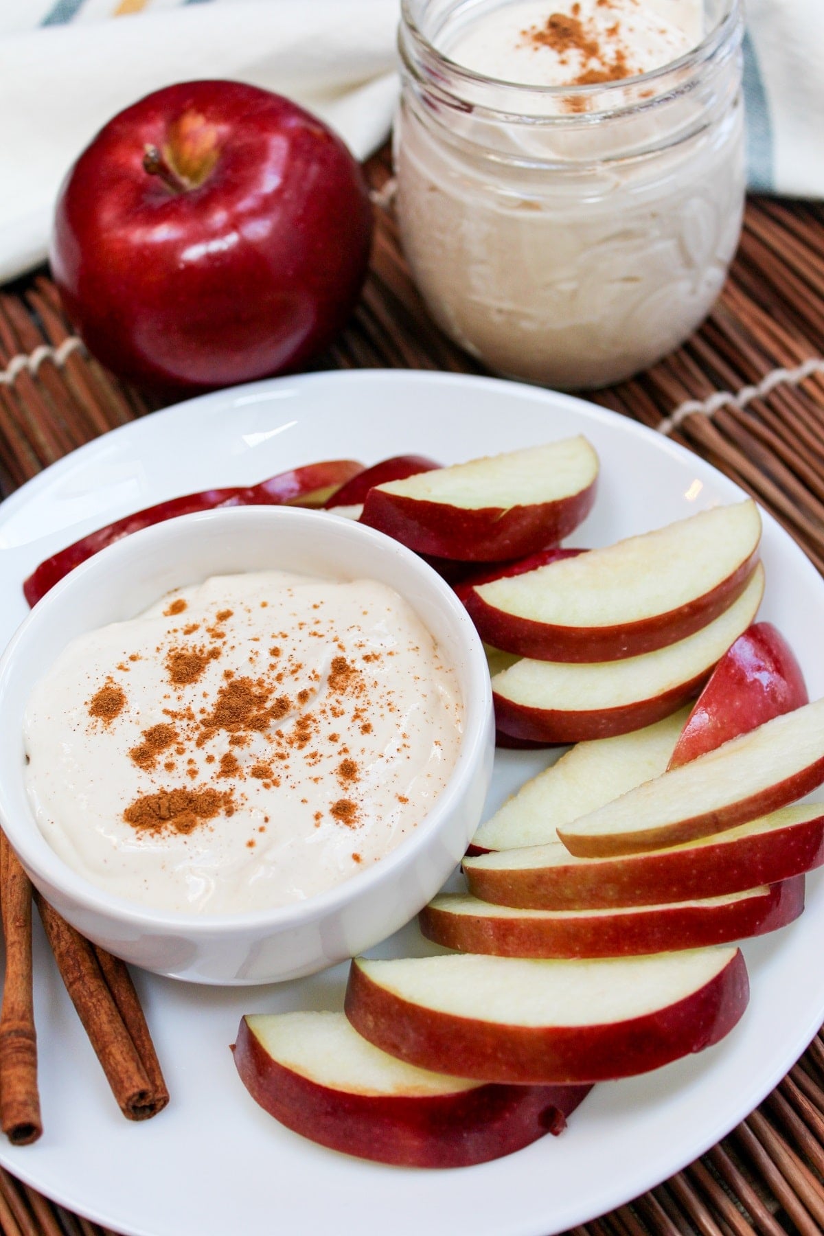 apple cider dip in a bowl with sliced apples