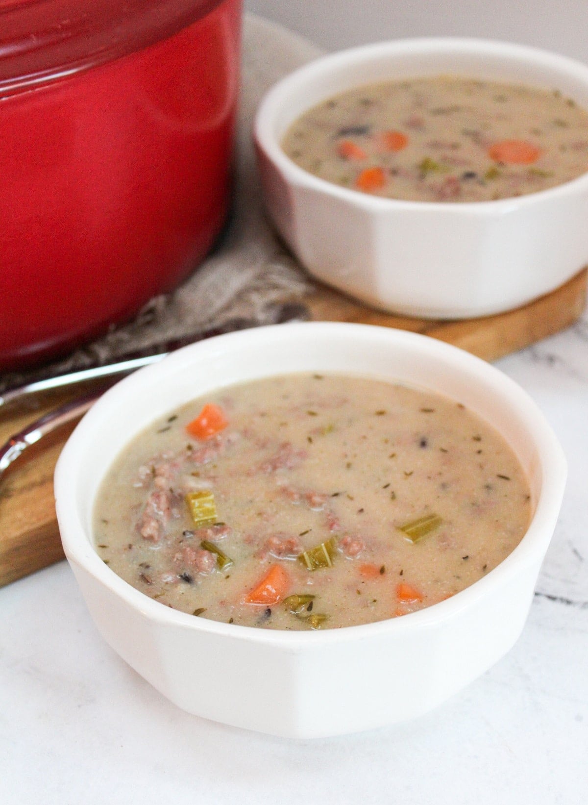 Creamy Wild Rice and Sausage Soup in a white bowl