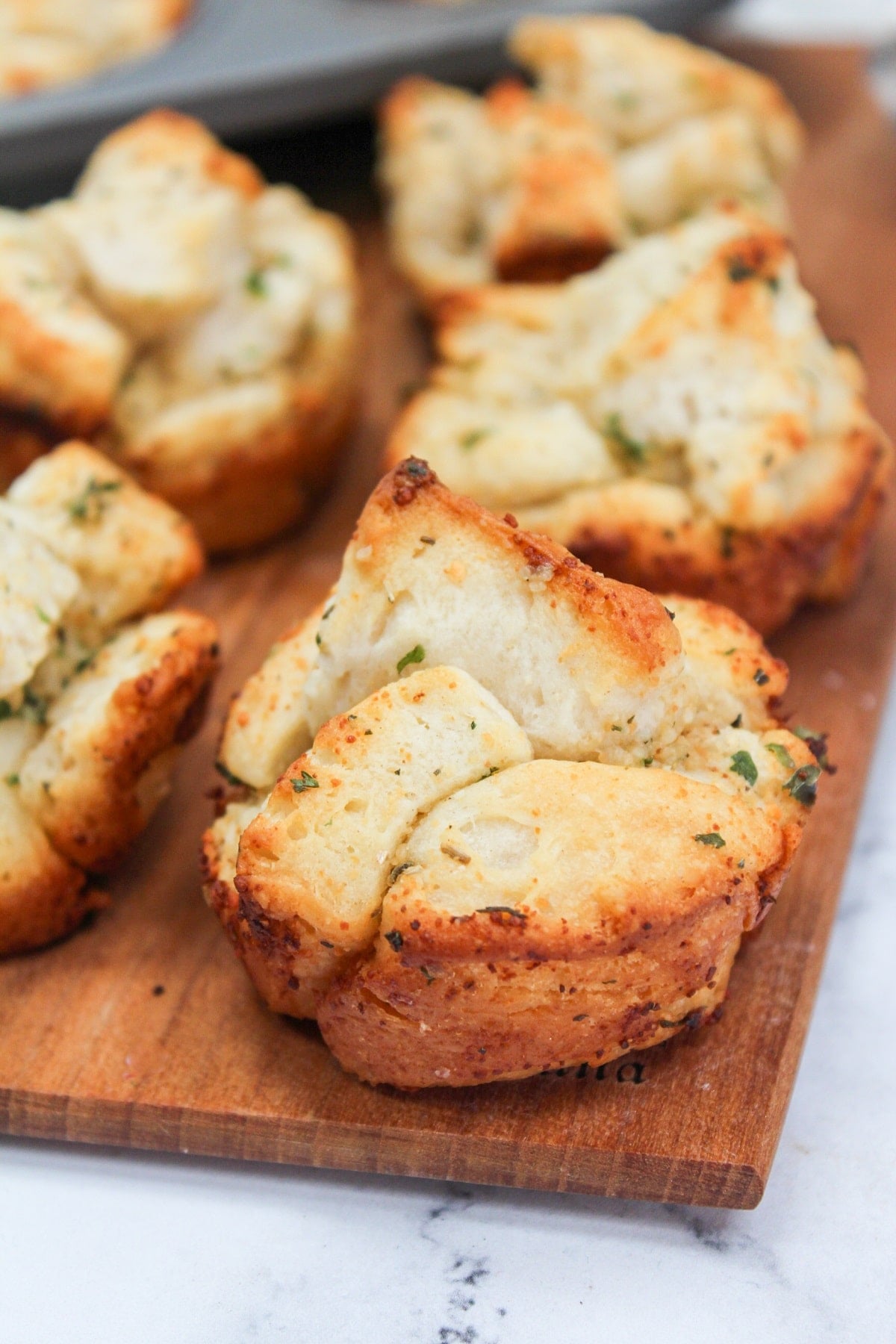 Garlic monkey bread on a wood tray
