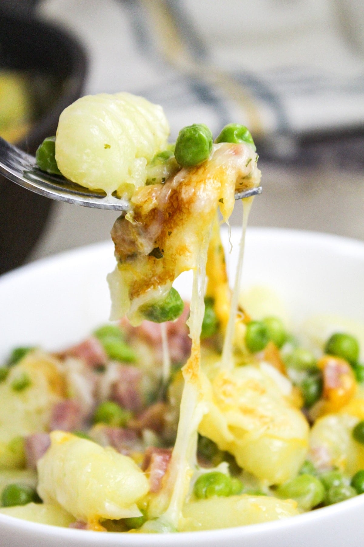 prep photos for ham and cheese gnocchi skillet scooped on a fork