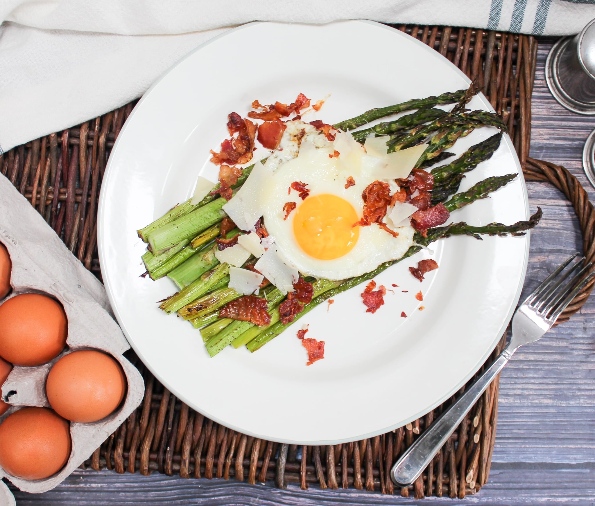 overhead shot of egg and asparagus salad on a plate