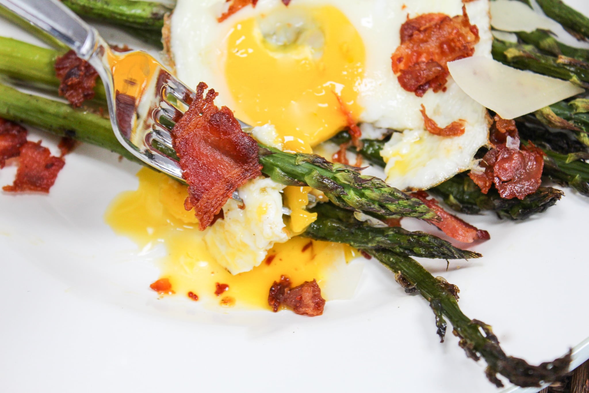 close up shot of asparagus salad with egg yolk broker