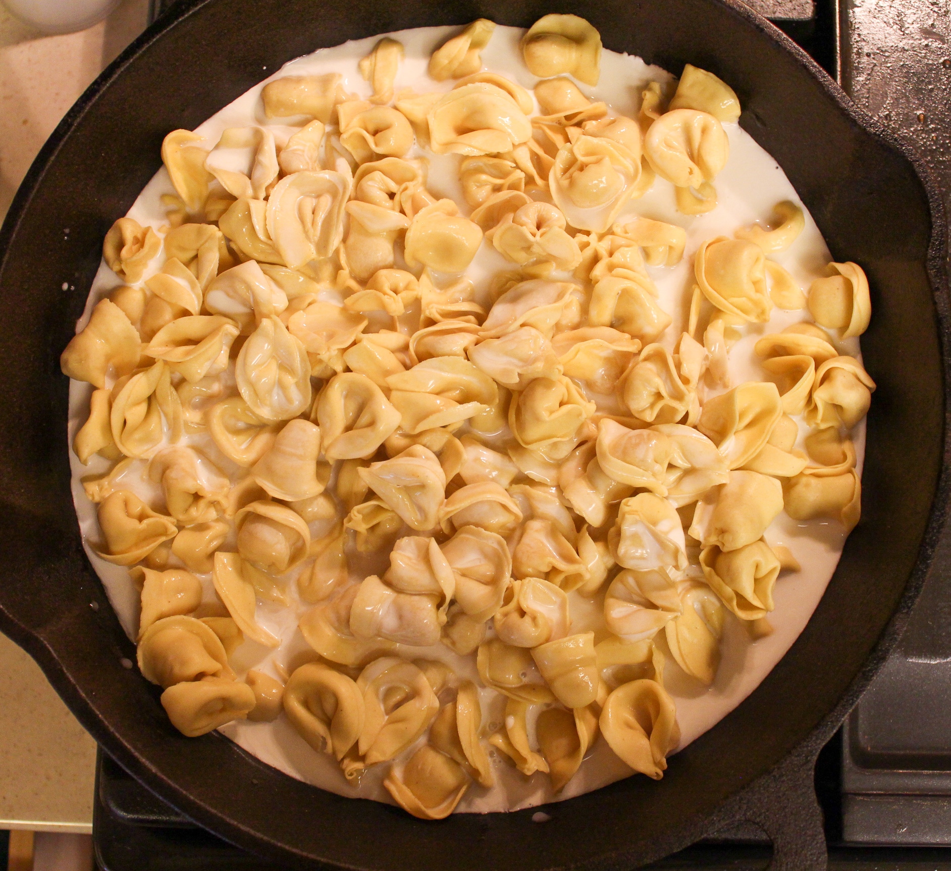 pasta in skillet with milk
