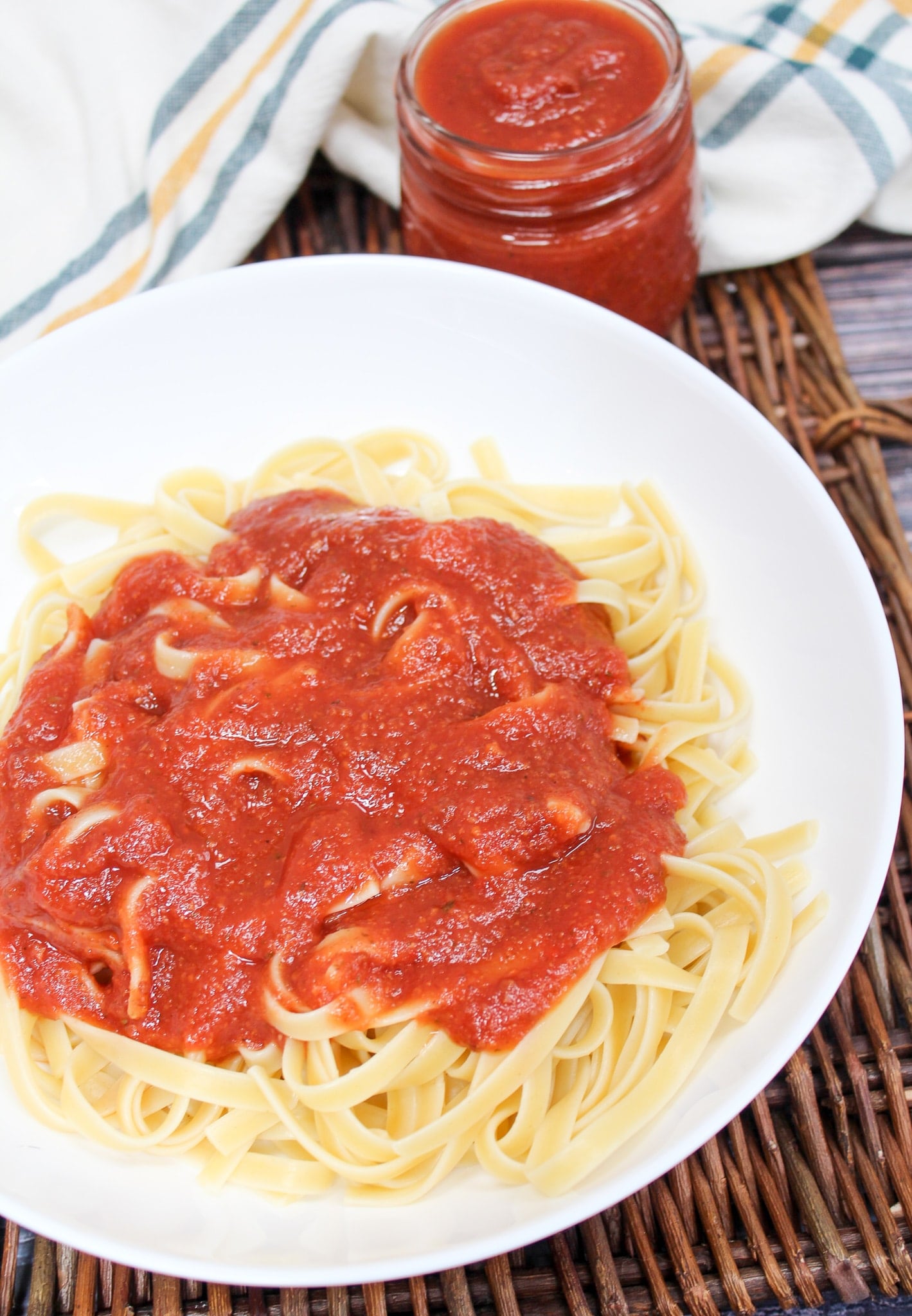 pasta sauce spooned over cooked pasta