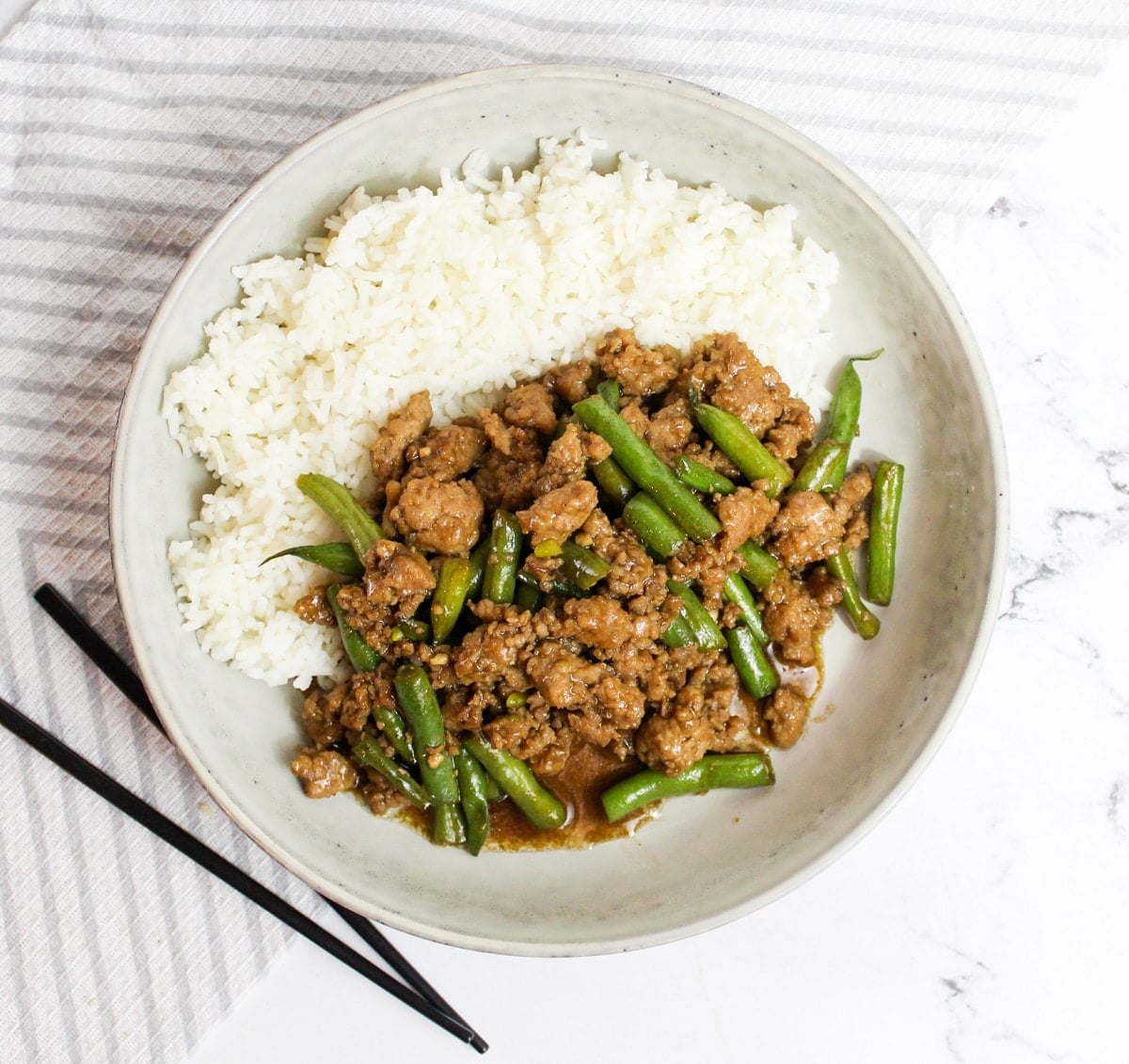 overhead photo Szechuan Green Beans and Ground Pork with chopsticks
