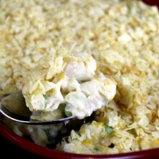 Pasta shells topped with potato chips scooped from a casserole dish