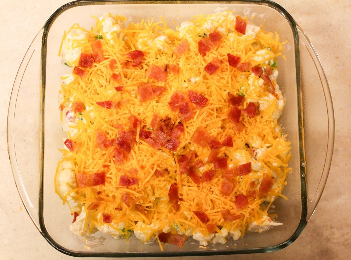 Casserole in a glass baking dish with bacon