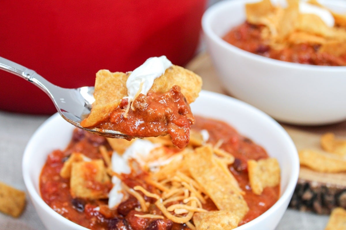chili in a bowl with corn chips and spoon