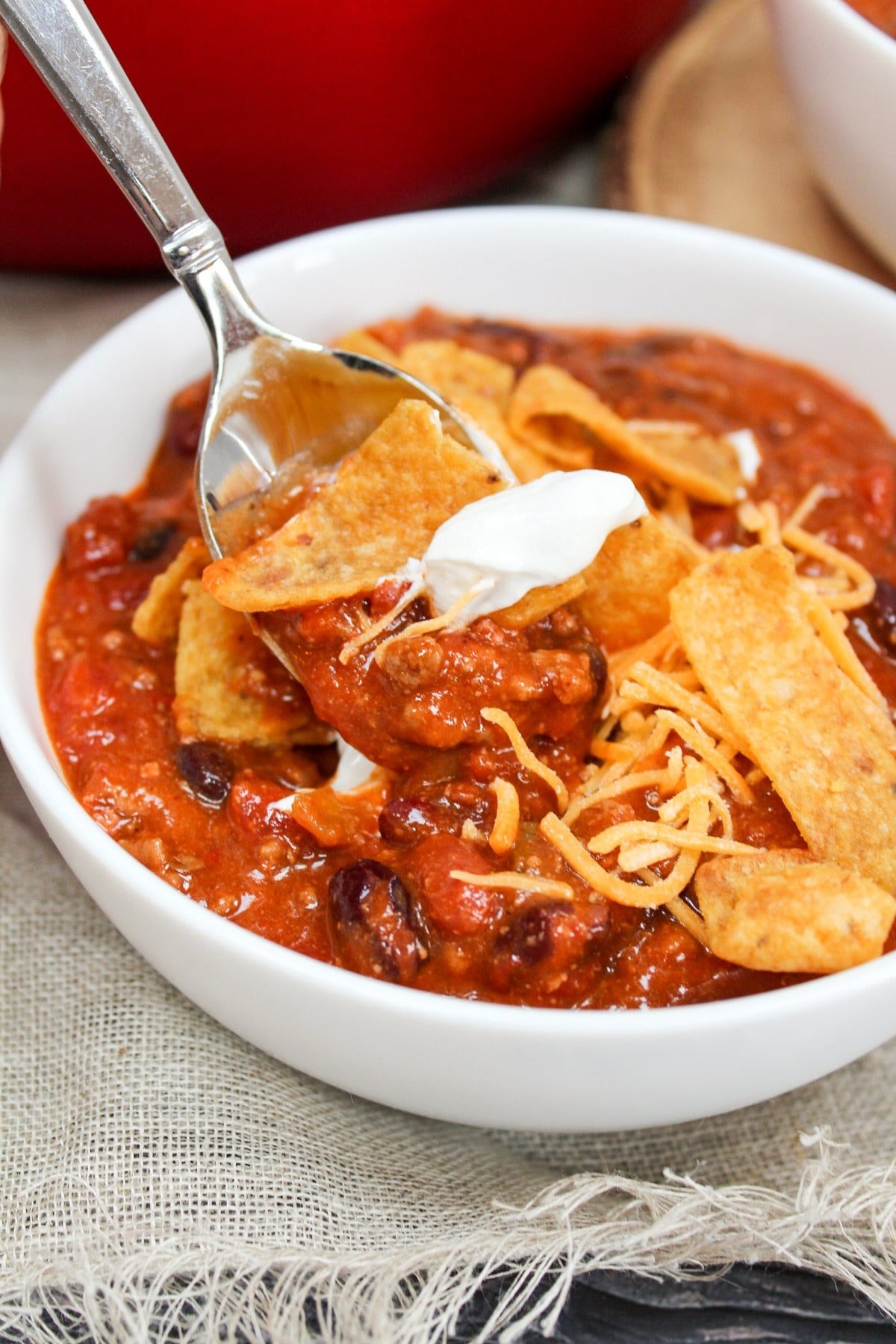 chili in a bowl with corn chips and spoon