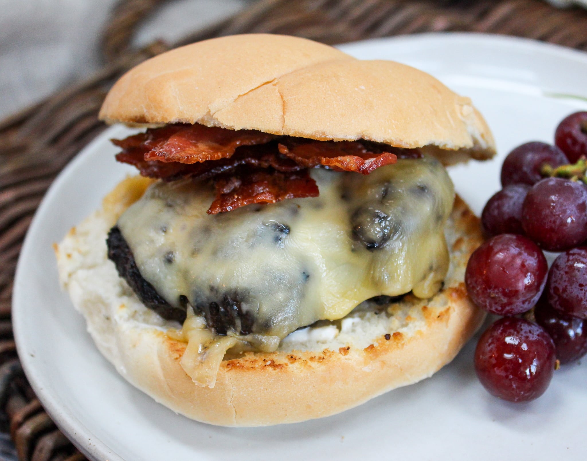 burger on a plate with grapes