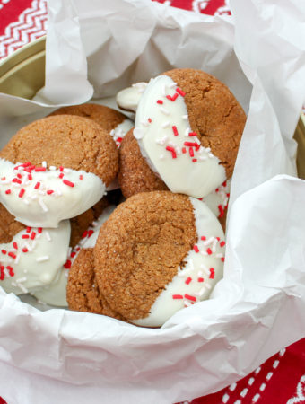 gingerbread cookied dipped in white chocolate in a cookie tin