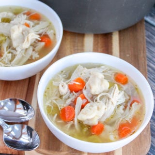 chicken dumpling soup in white bowls