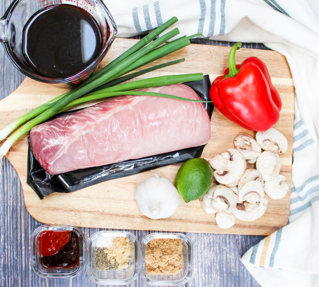 pork on a cutting board with ingredients