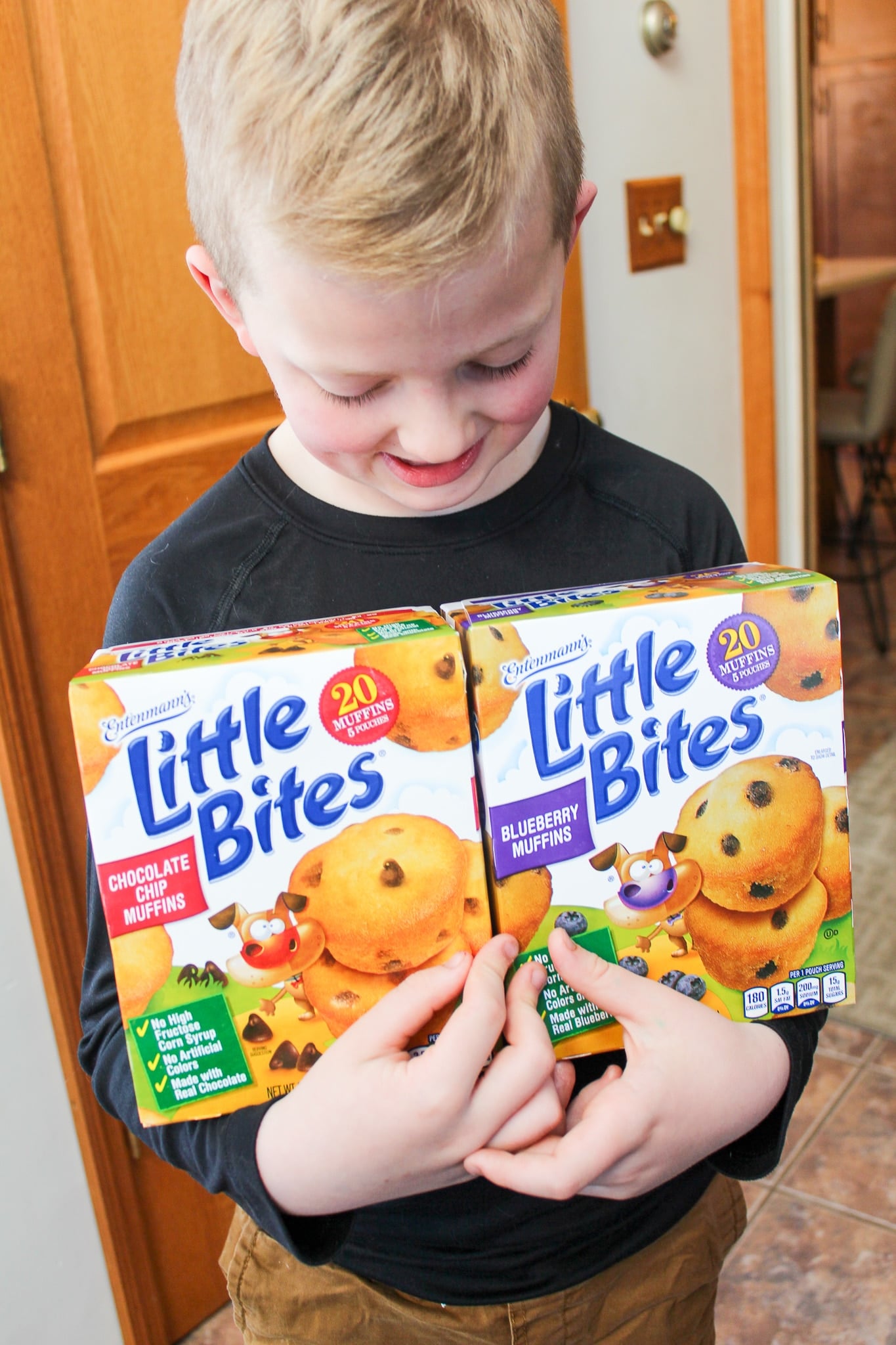 child with box of muffins