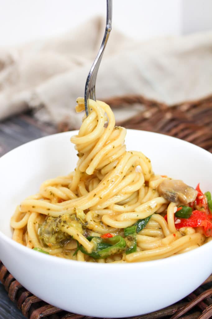 yellow curry noodle bowl in a bowl with a fork