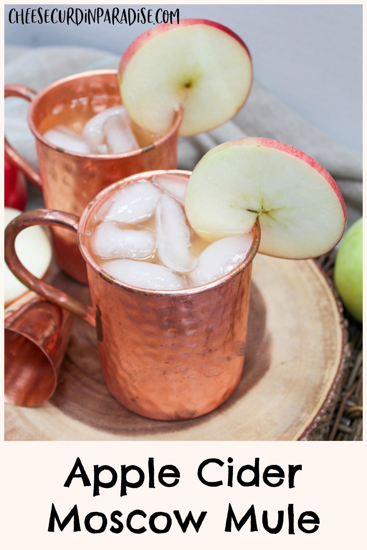 apple cider mule in a copper mug with an apple slice as a garnish