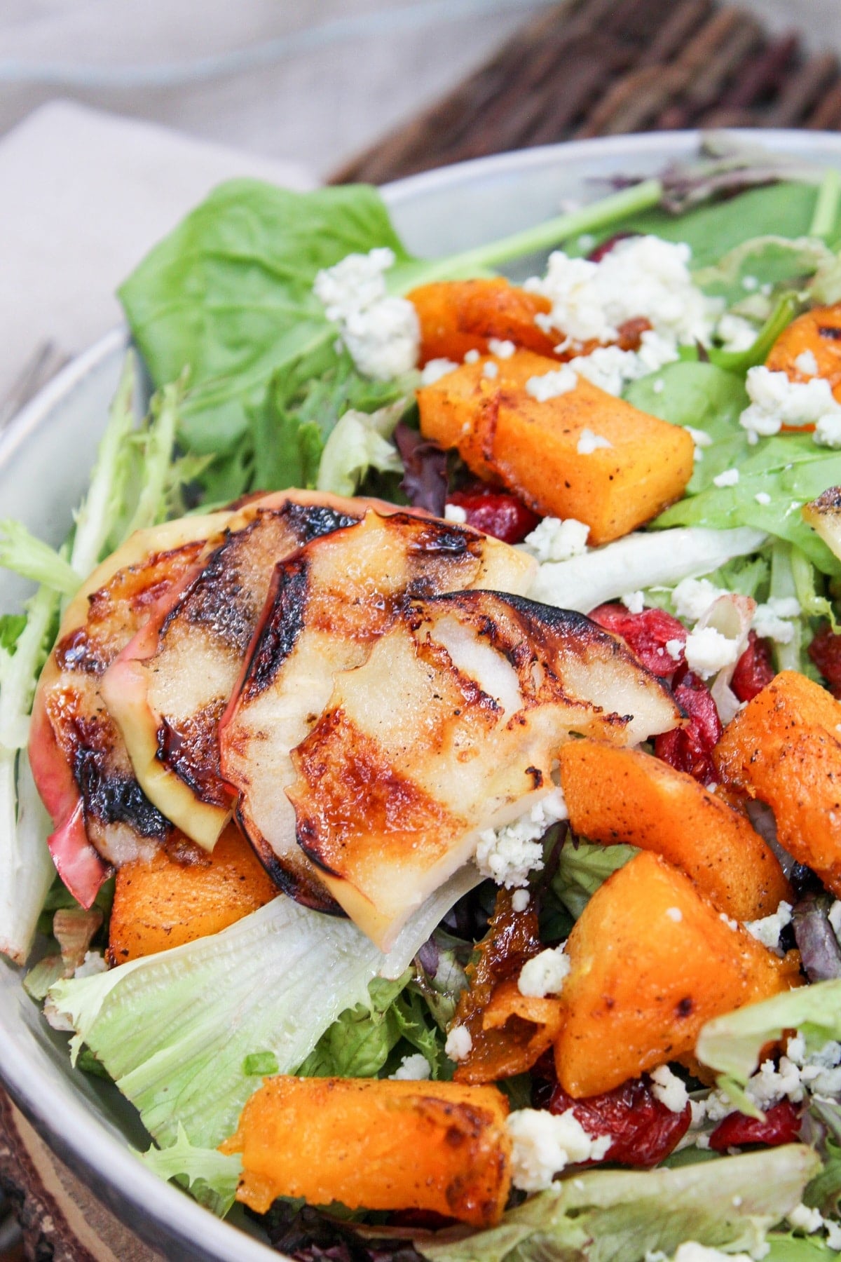salad in a bowl with grilled apples