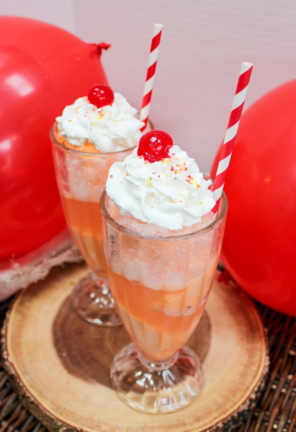 ice cream float in a glass with whipped cream and a cherry