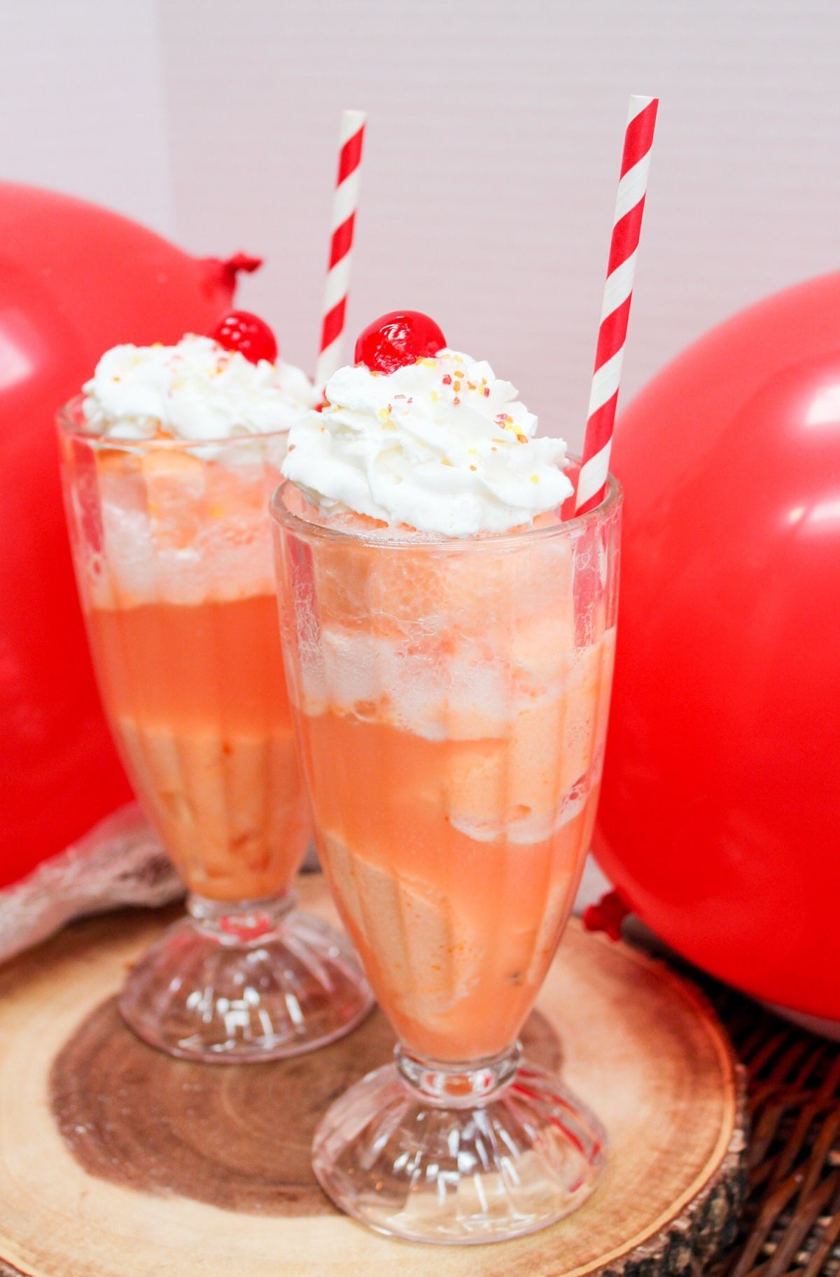 ice cream float in a glass with whipped cream and a cherry
