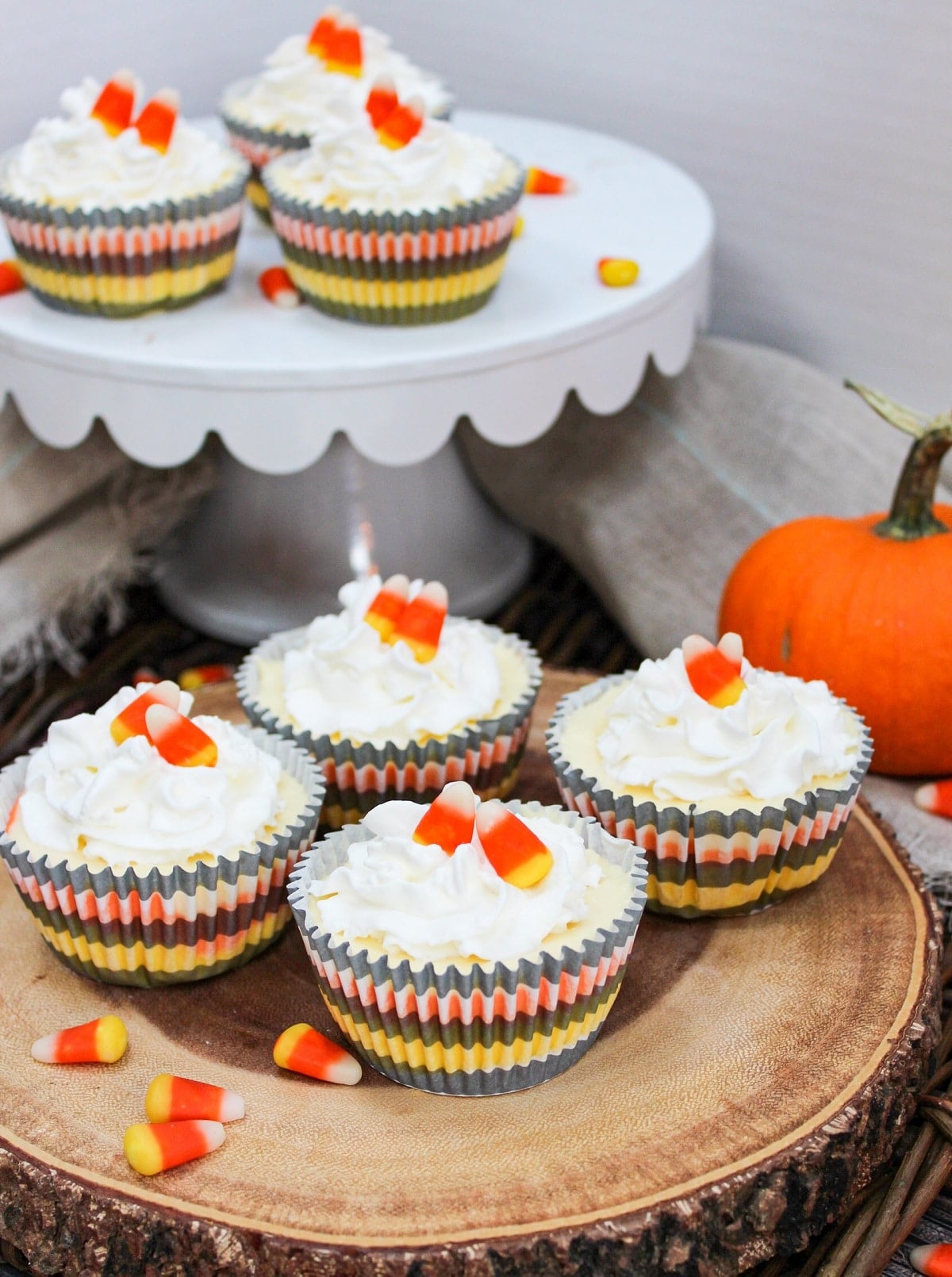 cheesescakes arranged on a wood block and a stand