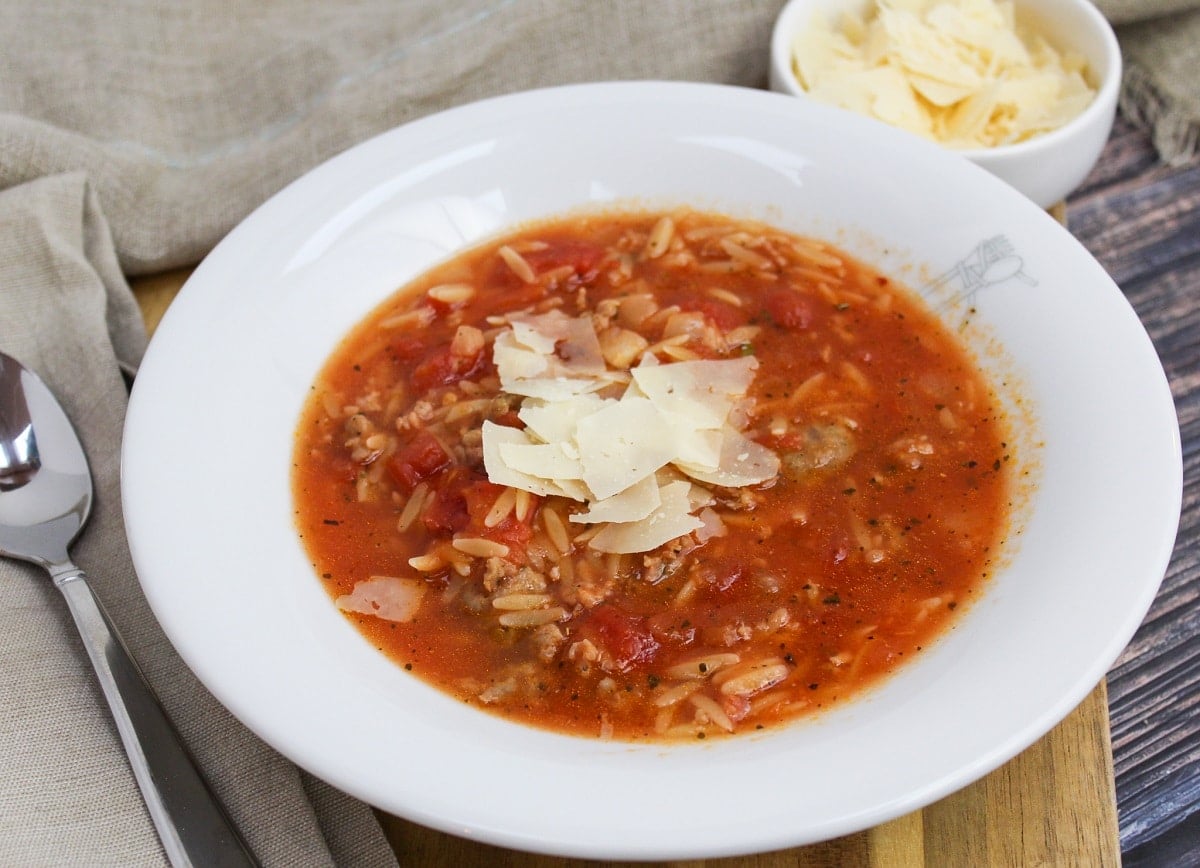 soup in a white bowl with cheese on top