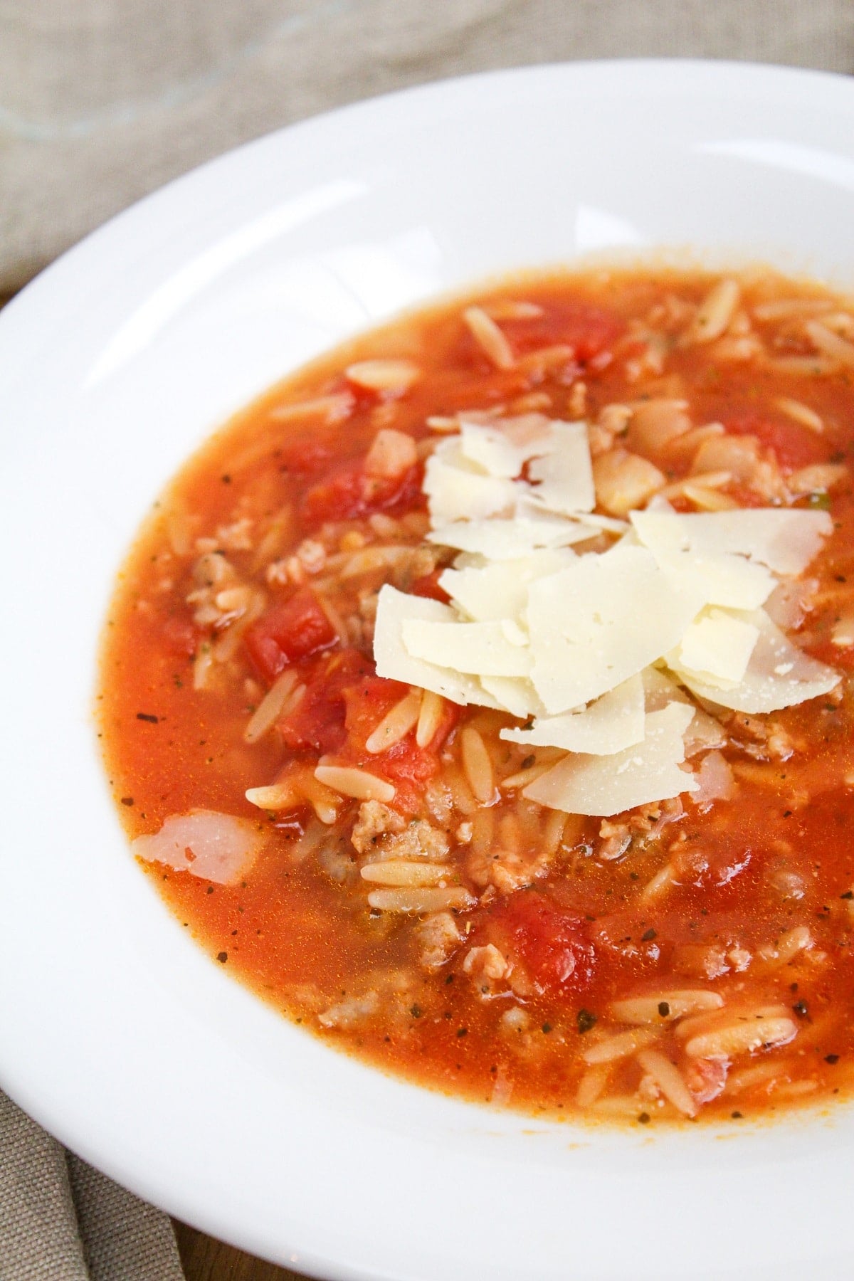 soup in a white bowl with cheese on top