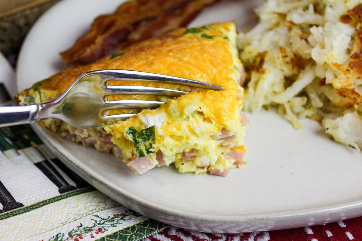 omelette on a plate and cut with a fork