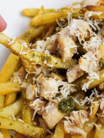 Pesto Chicken Fries with hand grabbing a fry